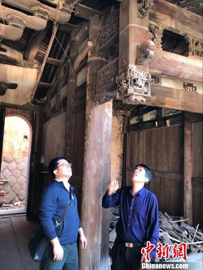 陈修俊(右)介绍陈氏古厝雕刻艺术。 陈仁杰 摄